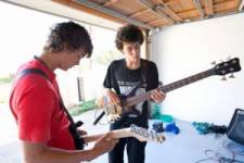 Kids plays guitar in the garage