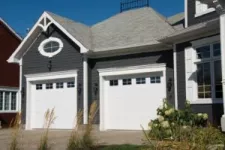 Blue House With 2 garage Doors