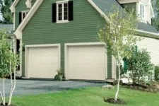 Green house with 2 garage doors